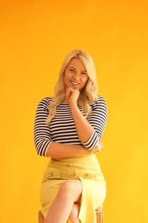 Woman sitting down looking happy