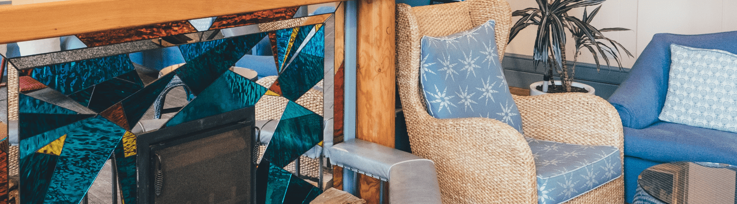 inside a home with a armchair next to a fireplace