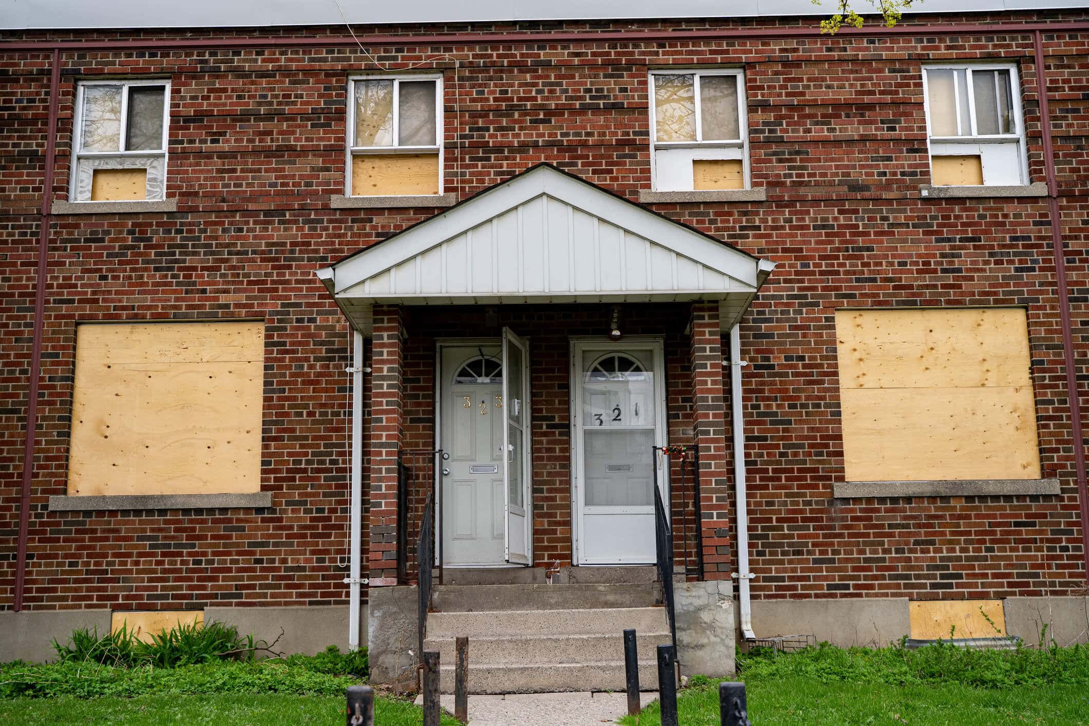 Partially boarded up abandoned residential building