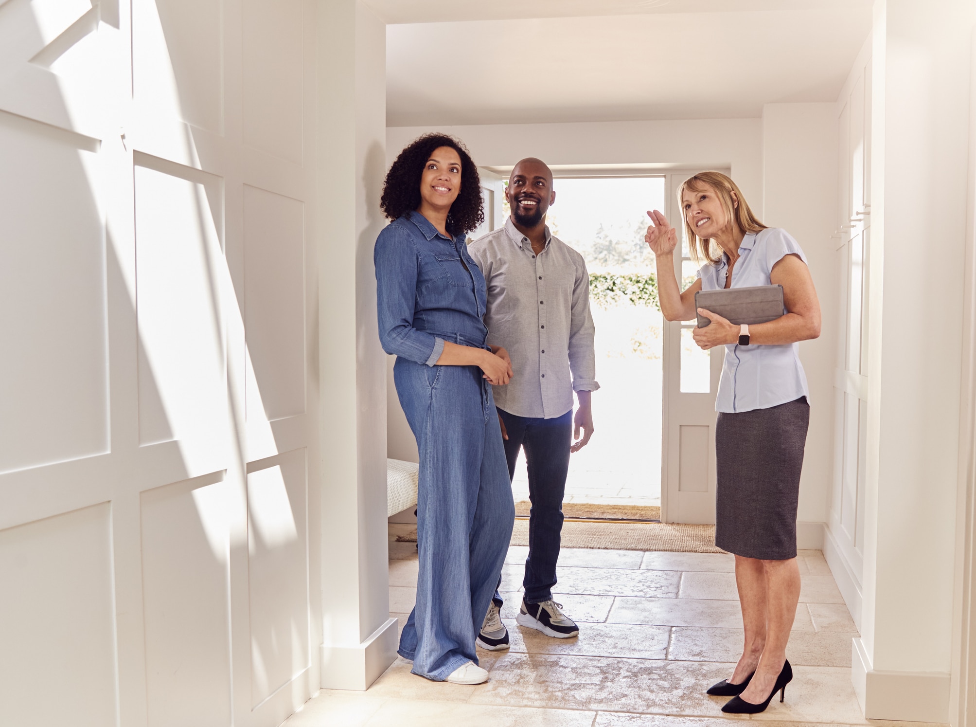 Couple and estate agent at property viewing